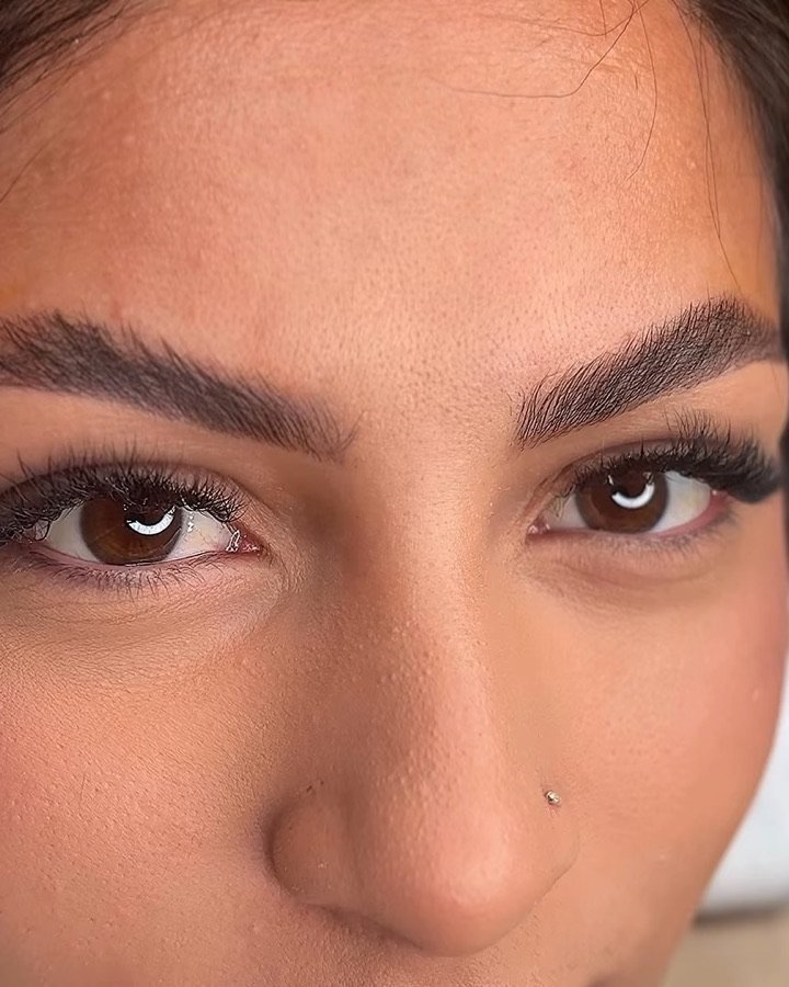 Grande plano de uma cliente deitada com sobrancelhas preenchidas e penteadas após brow lamination